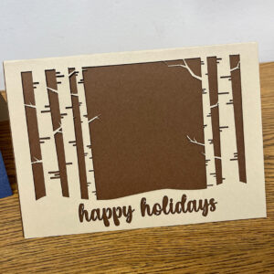 Laser-cut card, winter forest, "happy holidays"