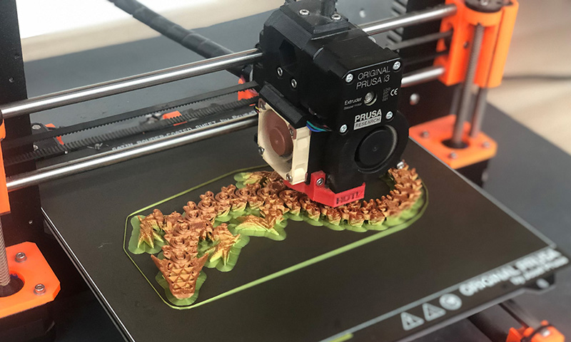 3D printed dragon on printer bed.