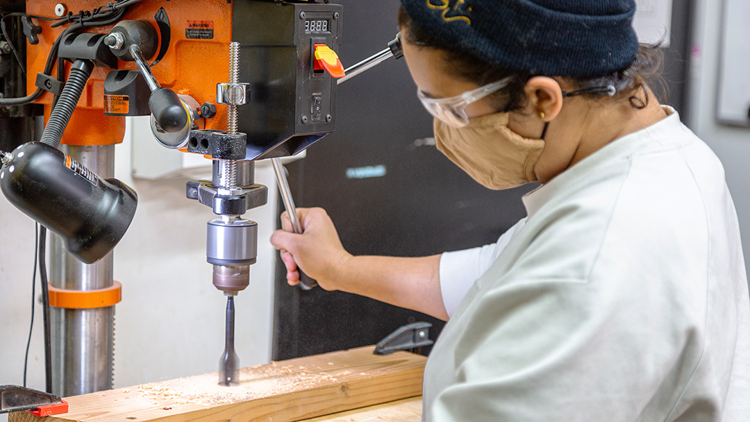 Person using Drill Press