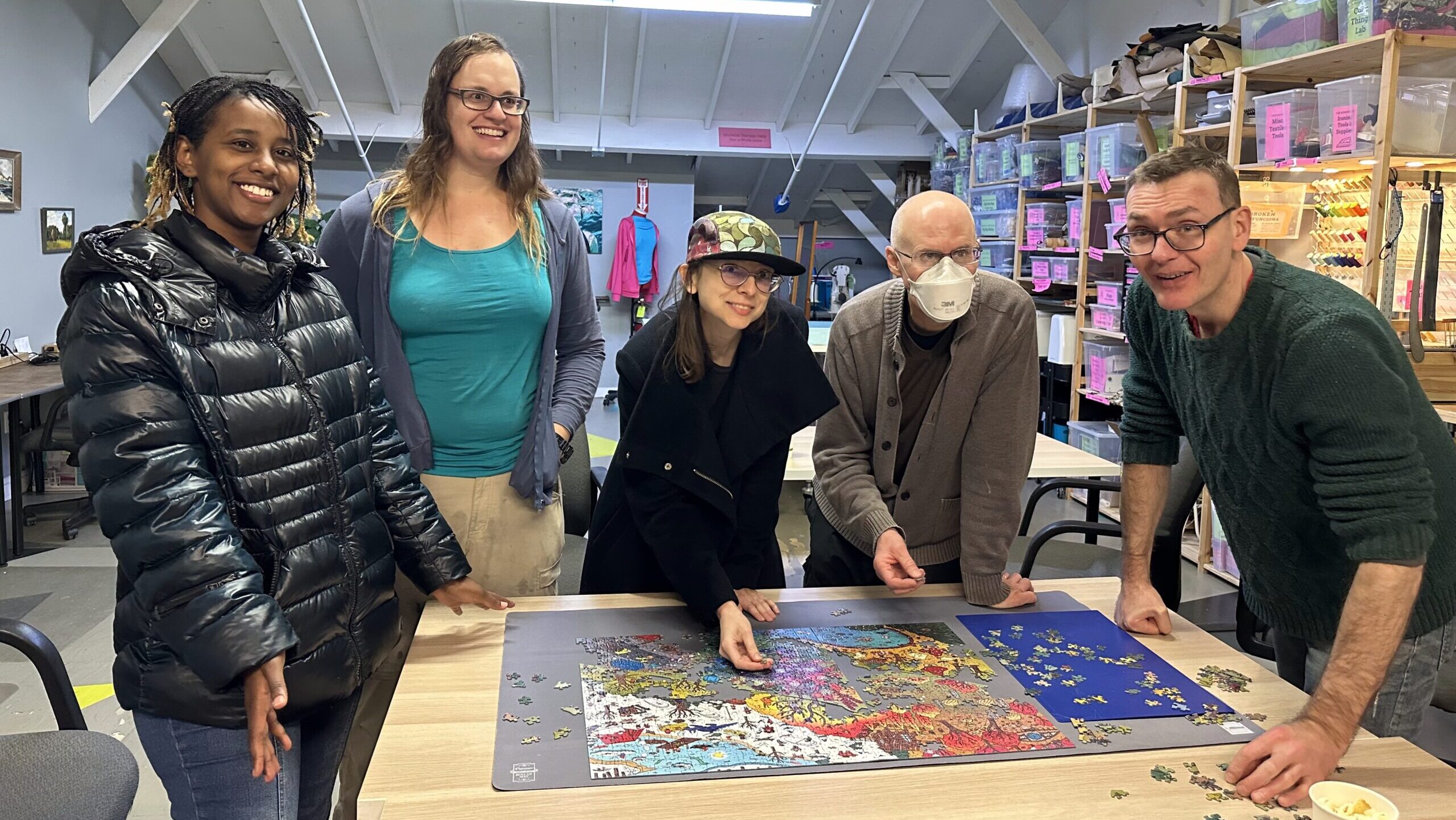 Ace members and guests working on a jigsaw puzzle from the Magic Puzzle Company